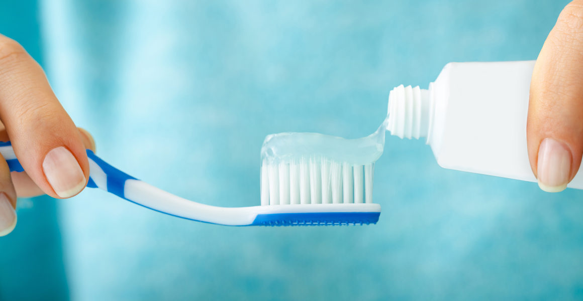 Putting toothpaste on a toothbrush - signifying tiny habits